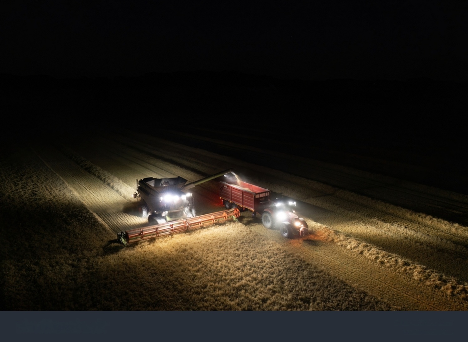 Combine harvester lighting up a field at night in Lincolnshire